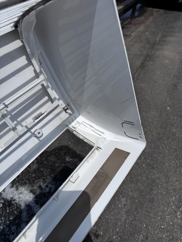 Technician washing mini split cover during deep cleaning service