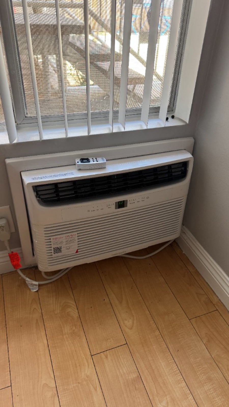 Installed through-wall Frigidaire AC under a window
